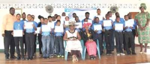 The programme’s participants pose with their certificates following the graduation ceremony. With them is Minister within the Education Ministry, Nicolette Henry (seated, left)