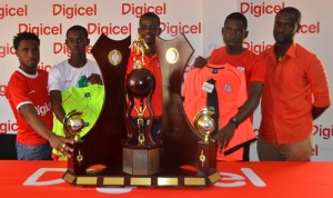 Digicel representative Sherwin Osborne (centre) poses with Head Coaches Vurlon Mills (left) and Anthony Stephens (right) and Team Captains Amanackie Forde (2nd left) and Tevin Crawford and the Lien Trophy yesterday at the Company’s Head Office.