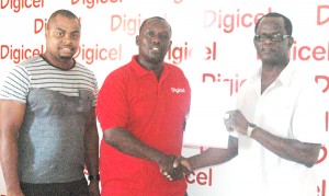 Digicel’s Events and Sponsorship Manager, Gavin Hope (centre) hands over the sponsorship package to Colin Boyce while Edison Jefford also shares the moment.