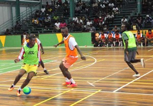 Festival City’s Eon Alleyne (with ball) advances towards the Agricola half in their clash on Monday night.
