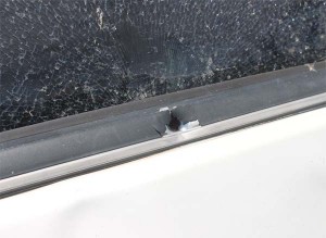 A bullet hole in the car’s door.