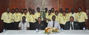 Members of the victorious Guyana U15 team display their accolades.  Sitting second from right are GCB head Drubahadur, Director of Sport Christopher Jones, GCB secretary Anand Sanasie and chairman of GCB senior selection panel Rayon Griffith. 