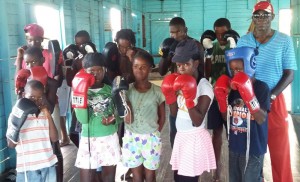 Members of the Ann’s Grove Gym pose with some of the boxing gear.  National coach Wincell Thomas is at right. 