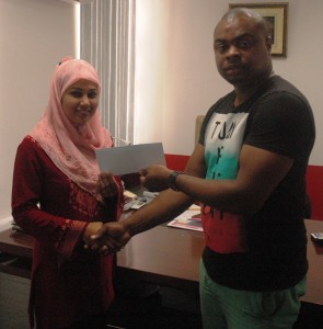 Administration Supervisor at R&D Engineering Services Inc. Suraiya Sahid (left) hand over the sponsorship cheque to Edison Jefford yesterday.