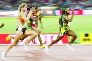 Shelly-Ann Fraser-Pryce of Jamaica (R) runs in front of Dafne Schippers of Netherlands (L) at the women’s 100 metres final during the 15th IAAF World Championships at the National Stadium in Beijing, China, August 24, 2015. (Reuters/Damir Sagolj)