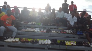 sneakers donation (adobe file) – Players and officials pose with the sneakers donated by Heinrod David to the Berbice Basketball Association. 