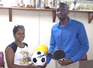 Verona Persaud and Wayne Francois: Caption- Director of Sport Christopher Jones (right0 hands over cheques and equipment to St. Cuthbert’s Mission representative Verona Persaid and East Bank Demerara’s Wayne Francois recently.