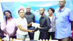 Head of the referee/judges committee, Romona Agard accepts the sponsorship cheque from Mr. Wills in the presence of Mr. Ninvalle (3rd left) and other GBA officials.    