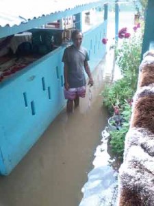 A resident standing in several inches of water