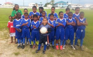 The young footballers from the Bartica team enjoy a photo op moments after defeating their Goshen counterparts.