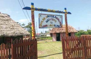 Totem pole entrance to Wamlan Paiku Lanau Pona/Whirl Wind Village