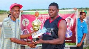  IMC Councilor Greg Butcher (left) hands over the winning trophy and other prizes to THT South Captain, Emon Wiggins. 