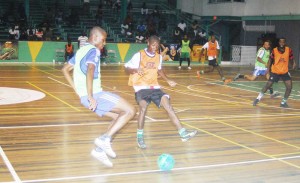Players battling for supremacy in the inaugural GT Beer Futsal Competition at the Cliff Anderson Sports Hall.