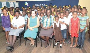 First Lady, Mrs. Sandra Granger (centre)  with teachers and students at the launching