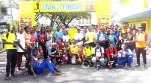 Courts Country Manager, Clyde de Haas (centre) takes a photo opportunity with all the winners from the various categories of the Courts 10km Road Race and 3km Walk/Jog yesterday morning.