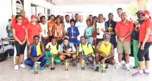 The respective winners from the AINLIM 10km Road Race yesterday morning pose for a photo opportunity with the staff and management of the Massy Group of Companies after the presentation ceremony. 