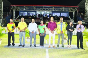 Minister Henry (4th left) flanked by GFF NC Chairman Clinton Urling (4th right) and other dignitaries at the March Past of Stag Elite League teams on Friday night at Leonora.
