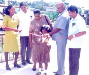 At left a young Ms Geneva Thomas with Ministry of Education officials during an opening ceremony for a newly rehabilitated school. 