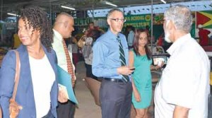 Minister of Business Dominic Gaskin interacting with an exhibitor at the Berbice Expo