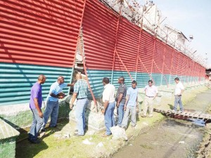 Welton Trotz, head of the Guyana Prison Service (2nd from left) with contractors at the Camp street prison yesterday.