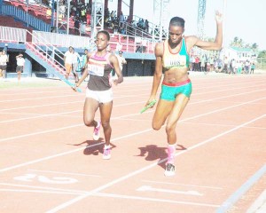 GDF’s Natrina Hooper (right) gets home just ahead of Police’s Jevina Sampson in the Women’s 800m Medley Relay yesterday at the National Track and Field Centre.