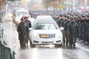 Police officers from New York and beyond gathered in Queens for the funeral.