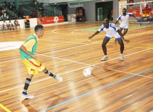  Part of the action in the clash between Republic Bank and National Insurance Scheme (NIS) on Thursday night at the Cliff Anderson Sports Hall.