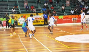 Action in the Inter-Ministry Futsal competition on Monday at the Cliff Anderson Sports Hall.