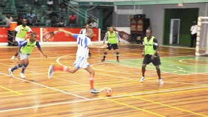 Battle last Thursday in the Inter Ministry Futsal tournament being contested at the Cliff Anderson Sports Hall. 