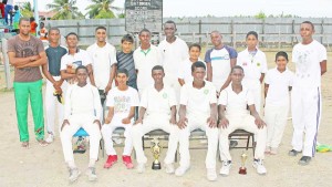 The winning Rose Hall Town Bakewell U-15 take a photo Op. with Coach Collis Butts after winning the match.