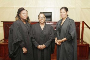 Mrs Dazzell is flanked by Justice Sandra Kurtzious (right) and Attorney Kim Kyte