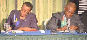 Foreign ministers, Maxine McLean of Barbados, and  Carl Greenidge of Guyana, sign the agreement.