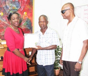  Minister Nicolette Henry presented Parris with a jersey decorated with the Jaguar emblem during his courtesy visit in the presence of Jeff Sankies.  
