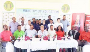Minister of Education, Rupert Roopnarine (4th R sitting) share the head table with members of the National Sports Commission, other cricket bigwigs, representatives of the sponsors and students of participating schools (standing behind).
