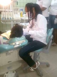 Dental Hygienist, Miss Jonnel Mortley providing Dental care to one of the children from the Save R Kids orphanage. 