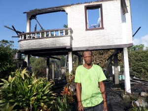 Patrick Whyte stands near his destroyed home.