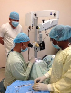 Minister of Public Health Dr. George Norton at GPHC’s Eye Theatre, observing as Dr. Ronnie Bhola conducts a surgery.
