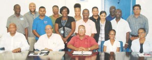 New GWI Chairman of the Board, Nigel Hinds (seated center); Chief Executive, Dr. Richard Van West Charles (2nd L) and Permanent Secretary of the Ministry of Communities, Emile McGarrell (2nd right standing) with the Corporate Management Team.