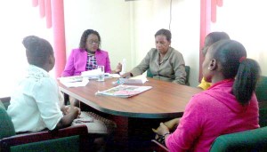 Some of the employees meeting with Minister Simona Broomes and a Senior Official within the Ministry.