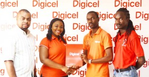 Digicel’s Sponsorship and Events Manager, Luanna Abrams (second, left) hands over the sponsorship package to PAS (Finance) within the Ministry of Education, Glendon Fogenay while PR and Marketing Officer of the Championships, Edison Jefford (left) and Second VP of Guyana Teacher’s Union (GTU), Julian Cambridge share the moment. 
