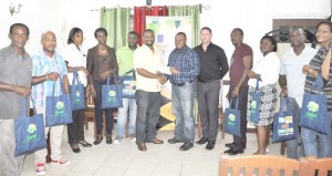 New GPC Inc. Finance Manager Dwayne Lovell (6th left) hands over the sponsorship cheque to Petra’s Troy Mendonca in the presence of teams representatives yesterday.