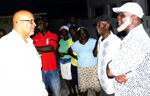 GWI CEO engages an Ann’s Grove Community resident as others look on.