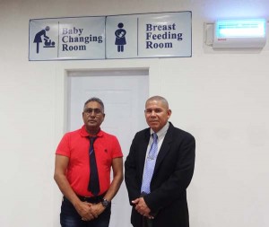 Minister of Public Health, Dr. George Norton (right) with Giftland CEO, Roy Beepat outside of the mall’s breastfeeding and baby changing room.