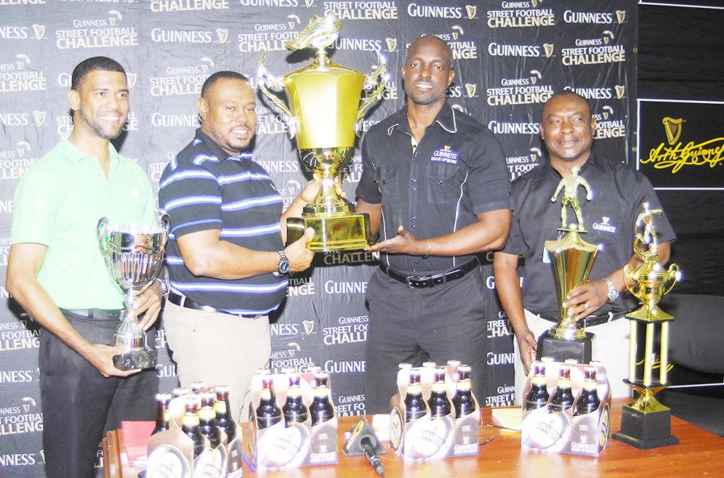 Guinness Brand Manager Lee Baptiste (2nd right ) hands over the winning trophies to Petra Organisation Troy Mendonca in the presence of Communications Manager Troy Peters and Aqua Mist Brand Manager Errol Nelson yesterday.