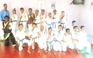 Students and teachers of the Guyana Mixed Martial Arts Karate Association display their winnings from the Guyana Open Martial Arts Championship. 