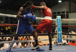 Guyana’s Dennis Thomas (right) lines up St Lucian Arthur Langelier for a thunderous right in their Middleweight bout. (Sean Devers photo)