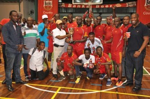 Foreign Affairs Minister Carl Greenidge (centre with cap) hnads over the winning trophy to Banks DIH Captain Phillip Rowley in the presence of teammates, members of the Organising team and Banks DIH officials.