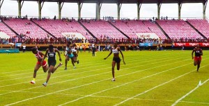  East Coast’s, Kenisha Phillips (lane 4) cracks the 100m Girls’ Under-16 record in 12.0 seconds yesterday at the National Schools’ Championships at the National Stadium. 