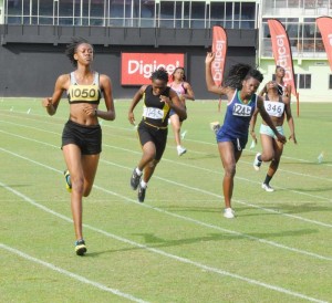 Upper Demerara’s Kenisha Prescott (left) comfortably strides to victory in the 200m U-20 Girls’ race to complete a sprint double yesterday.