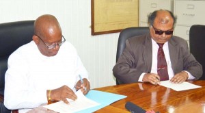 Minister of Finance Hon. Winston Jordan and Fedders Lloyd Country Representative Ajay Jha during the MOU signing.